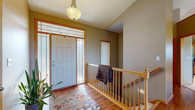 4374 Shetland Pl NW, Rochester, MN 55901 - foyer entrance featuring wood finished floors, vaulted ceiling, and baseboards