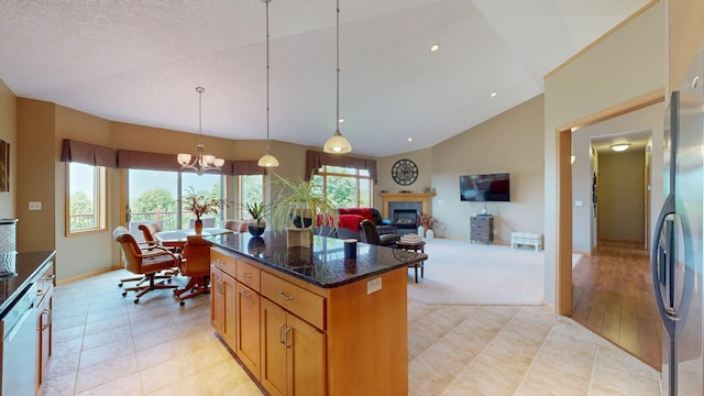 4374 Shetland Pl NW, Rochester, MN 55901 - kitchen with a glass covered fireplace, lofted ceiling, a kitchen island, dishwashing machine, and dark stone countertops