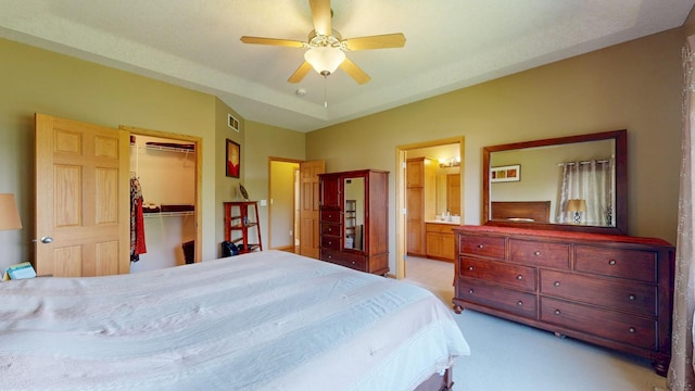 4374 Shetland Pl NW, Rochester, MN 55901 - bedroom featuring a spacious closet, connected bathroom, a closet, ceiling fan, and light colored carpet