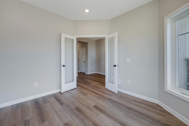 15354 112th Ave N, Dayton, MN 55369 - unfurnished room with french doors, wood finished floors, baseboards, and recessed lighting