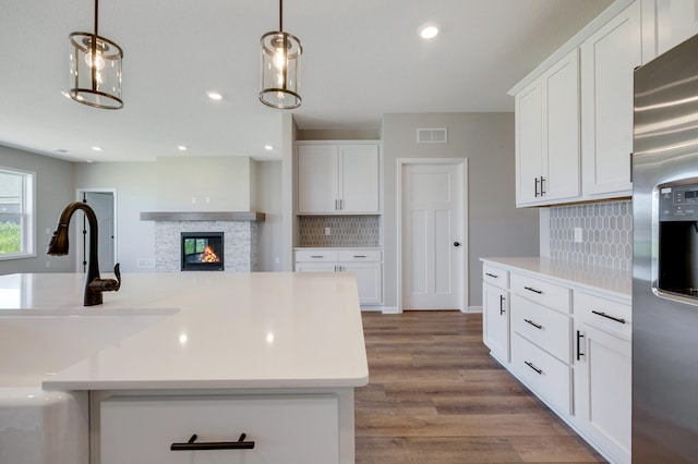 15354 112th Ave N, Dayton, MN 55369 - kitchen with stainless steel fridge, a sink, decorative backsplash, white cabinetry, and recessed lighting
