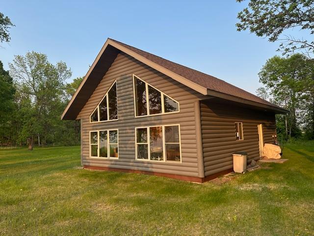 19373 Ethel Beach Rd NE, Kelliher, MN 56650 - view of property exterior with a yard and faux log siding