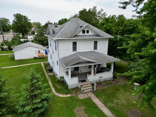 506 3rd St SW, Wadena, MN 56482 - american foursquare style home featuring a shingled roof, a front yard, covered porch, and central air condition unit