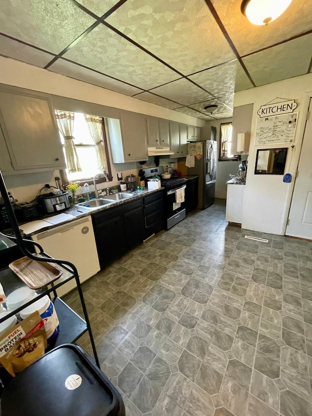 506 3rd St SW, Wadena, MN 56482 - kitchen with a sink, appliances with stainless steel finishes, under cabinet range hood, and plenty of natural light