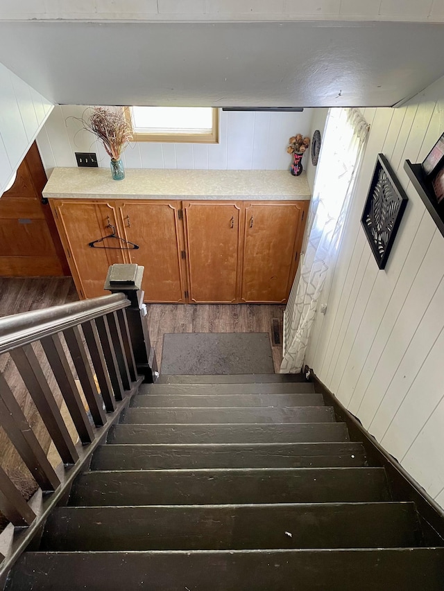 506 3rd St SW, Wadena, MN 56482 - stairway featuring wood-type flooring and wooden walls