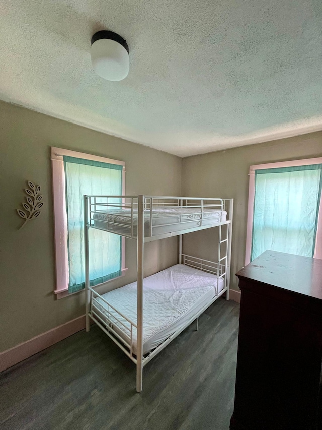 506 3rd St SW, Wadena, MN 56482 - bedroom featuring a textured ceiling, wood finished floors, and baseboards