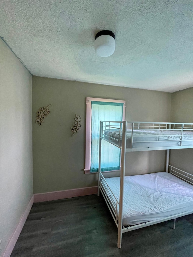 506 3rd St SW, Wadena, MN 56482 - bedroom with wood finished floors, a textured ceiling, and baseboards