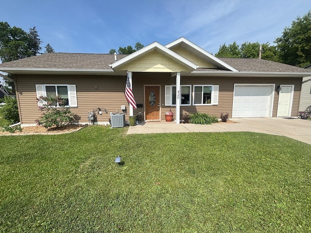 420 14th St, Brainerd, MN 56401 - view of front facade featuring driveway, an attached garage, a front yard, central AC unit, and a shingled roof