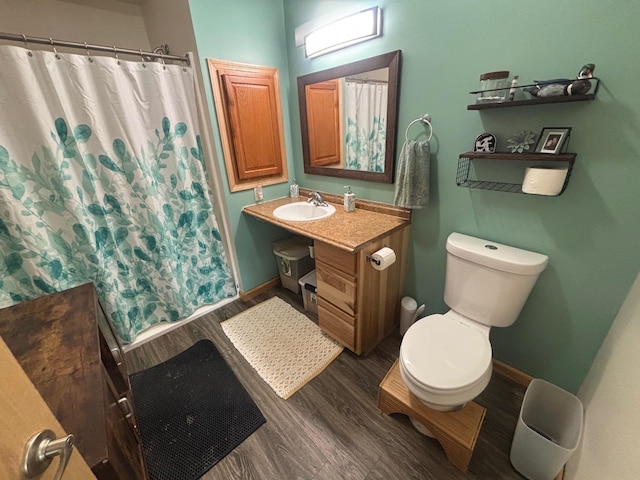 420 14th St, Brainerd, MN 56401 - bathroom with wood finished floors, vanity, toilet, and baseboards