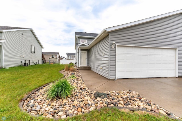1131 38 1/2 Ave W, West Fargo, ND 58078 - view of home's exterior featuring concrete driveway, a yard, and an attached garage