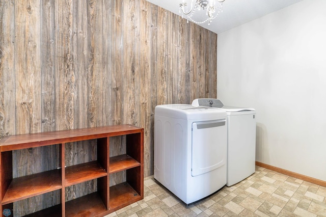 1131 38 1/2 Ave W, West Fargo, ND 58078 - laundry room with separate washer and dryer, wooden walls, and a chandelier