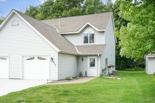 12233 191st Ave NW, Elk River, MN 55330 - traditional-style house featuring a shingled roof, driveway, a front yard, central air condition unit, and a garage