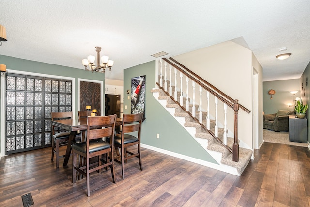 12233 191st Ave NW, Elk River, MN 55330 - dining room with wood finished floors, stairway, a chandelier, baseboards, and a textured ceiling