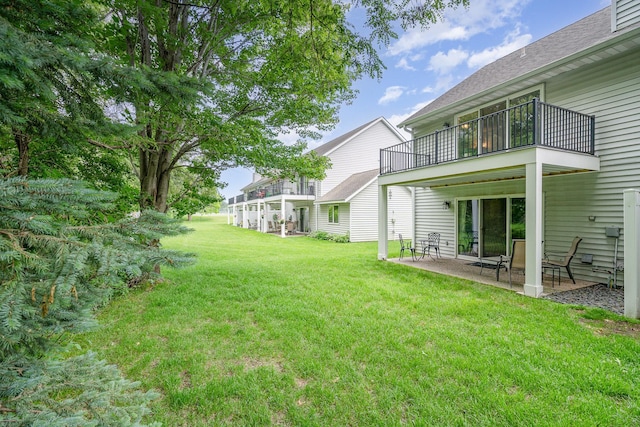 12233 191st Ave NW, Elk River, MN 55330 - view of grassy yard featuring a balcony and a patio