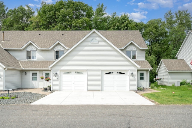 12233 191st Ave NW, Elk River, MN 55330 - traditional-style home featuring concrete driveway, roof with shingles, and an attached garage