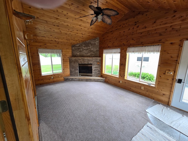 415 9th St N, Cannon Falls, MN 55009 - unfurnished living room featuring wood walls, wooden ceiling with exposed beams, carpet flooring, a ceiling fan, and a fireplace