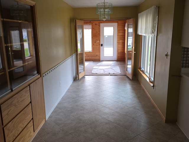 415 9th St N, Cannon Falls, MN 55009 - doorway with baseboards, a chandelier, and wood walls