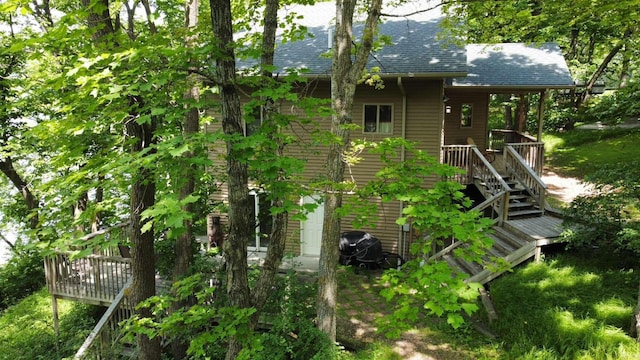 37791 Mallard Loop, Edna Twp, MN 56573 - back of property with a shingled roof, a wooden deck, and stairs