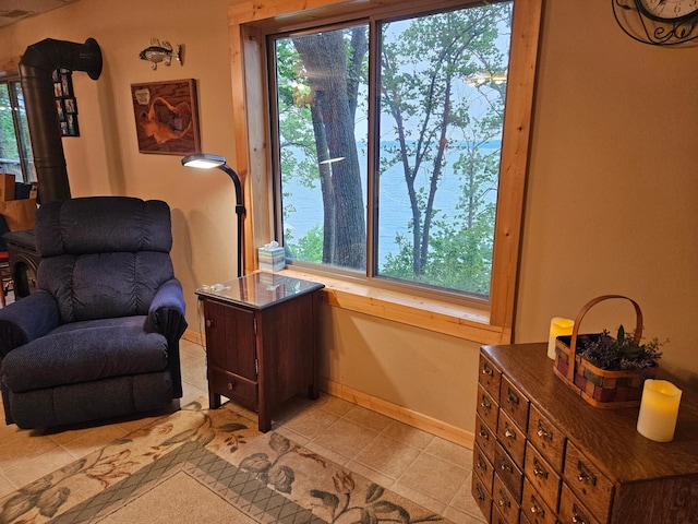 37791 Mallard Loop, Edna Twp, MN 56573 - sitting room with light tile patterned flooring and a wood stove