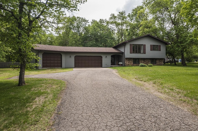 42174 Bur Oak Hills Loop, Pelican Twp, MN 56572 - split level home featuring asphalt driveway, an attached garage, and a front lawn