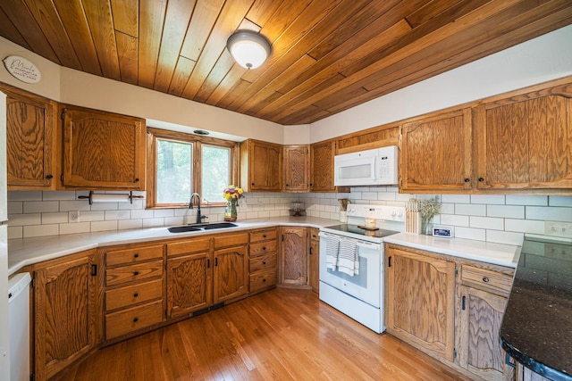 42174 Bur Oak Hills Loop, Pelican Twp, MN 56572 - kitchen with white appliances, a sink, brown cabinetry, decorative backsplash, and light wood-type flooring