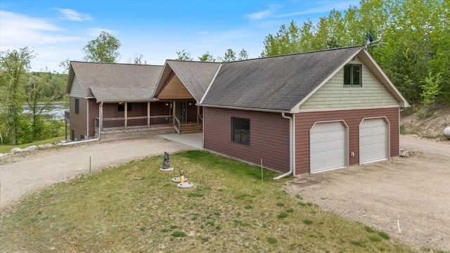 32305 Little E Lake Rd, Bigfork, MN 56628 - view of front of house featuring covered porch, driveway, a garage, and a shingled roof