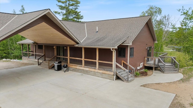 32305 Little E Lake Rd, Bigfork, MN 56628 - view of front of home with roof with shingles and covered porch