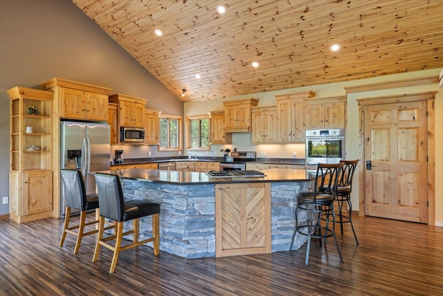 32305 Little E Lake Rd, Bigfork, MN 56628 - kitchen with stainless steel appliances, dark countertops, a breakfast bar area, high vaulted ceiling, and dark wood finished floors