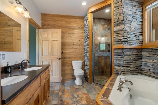 32305 Little E Lake Rd, Bigfork, MN 56628 - bathroom with a jetted tub, a shower stall, double vanity, stone finish floors, and wood walls