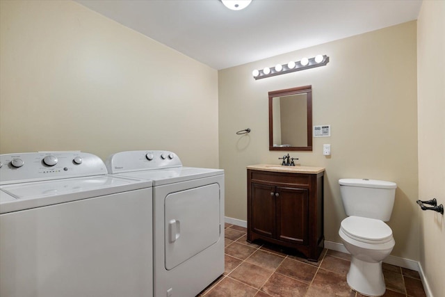 32305 Little E Lake Rd, Bigfork, MN 56628 - washroom with independent washer and dryer, baseboards, and dark tile patterned floors