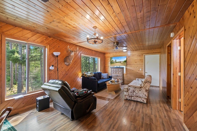 32305 Little E Lake Rd, Bigfork, MN 56628 - living room featuring hardwood / wood-style flooring, wood ceiling, a chandelier, plenty of natural light, and wood walls