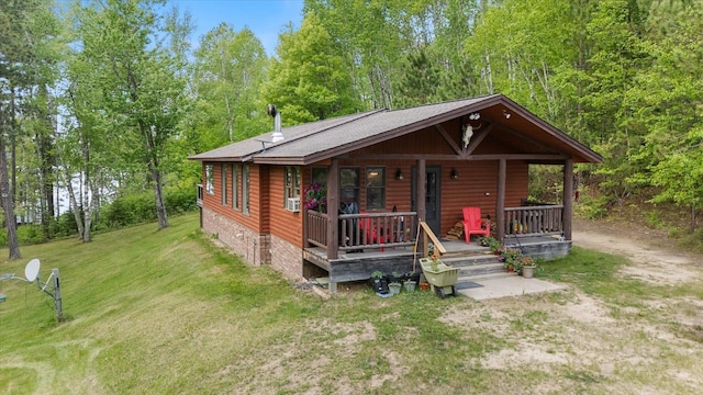 32305 Little E Lake Rd, Bigfork, MN 56628 - chalet / cabin featuring covered porch, a front lawn, log veneer siding, and roof with shingles