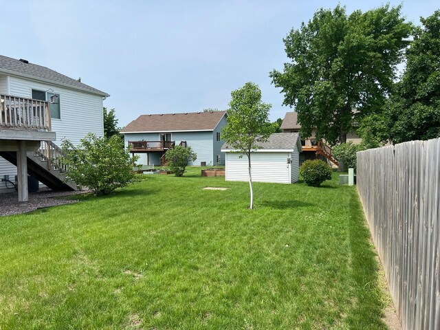 728 7th St, Litchfield, MN 55355 - view of yard with stairs, a wooden deck, and an outbuilding