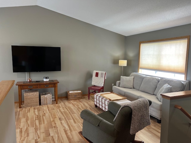 728 7th St, Litchfield, MN 55355 - living room featuring light wood-style floors, vaulted ceiling, and baseboards