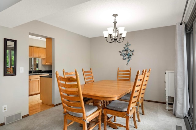4839 Spring Cir, Minnetonka, MN 55345 - dining area featuring a chandelier and light colored carpet