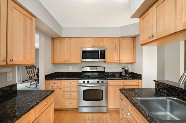 4839 Spring Cir, Minnetonka, MN 55345 - kitchen with appliances with stainless steel finishes, light brown cabinets, light wood-style floors, and dark stone countertops