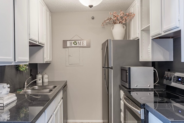 433 7th St Unit 2317, Minneapolis, MN 55415 - kitchen with stainless steel appliances, a sink, white cabinetry, dark countertops, and a textured ceiling