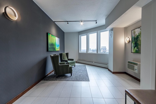 433 7th St Unit 2317, Minneapolis, MN 55415 - sitting room featuring a baseboard radiator, rail lighting, an AC wall unit, baseboards, and a textured ceiling