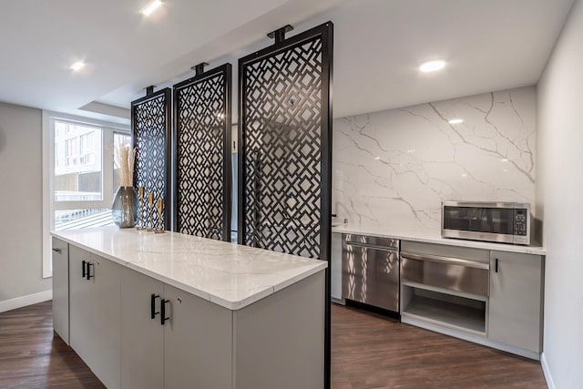 433 7th St Unit 2317, Minneapolis, MN 55415 - kitchen with stainless steel microwave, dark wood-style floors, a warming drawer, light stone counters, and recessed lighting