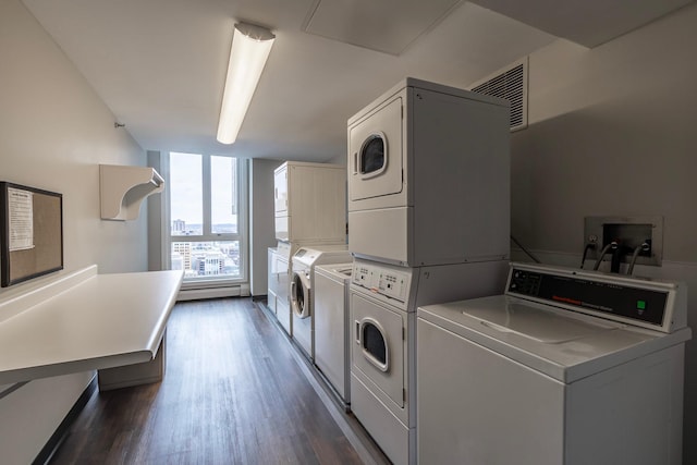 433 7th St Unit 2317, Minneapolis, MN 55415 - communal laundry room with stacked washer and clothes dryer, washing machine and dryer, dark wood-type flooring, and baseboard heating