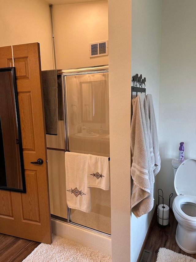 21250 Farm View Dr, Park Rapids, MN 56470 - full bathroom featuring wood finished floors, a shower stall, and toilet