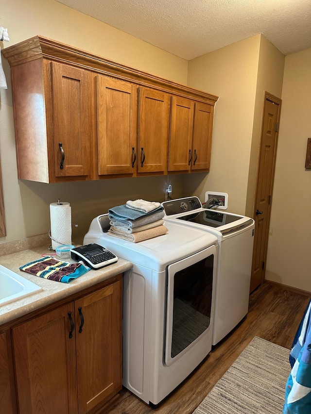 21250 Farm View Dr, Park Rapids, MN 56470 - laundry room with independent washer and dryer, cabinet space, wood finished floors, and a textured ceiling