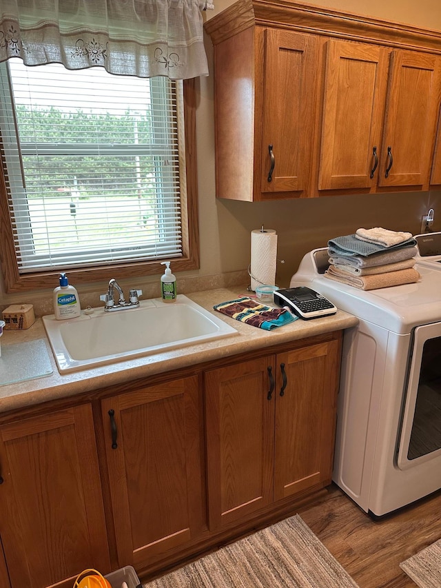 21250 Farm View Dr, Park Rapids, MN 56470 - washroom with cabinet space, washing machine and dryer, and wood finished floors