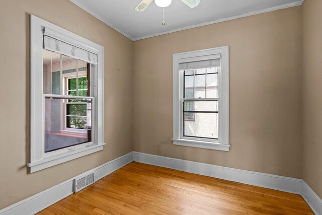 3553 Dupont Ave S, Minneapolis, MN 55408 - unfurnished room featuring light wood finished floors, crown molding, baseboards, and ceiling fan
