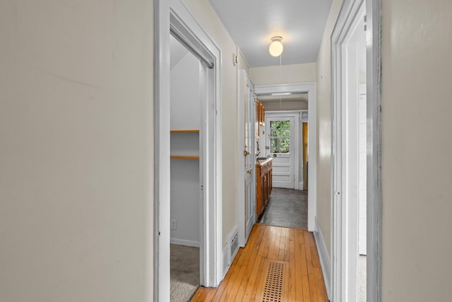 3553 Dupont Ave S, Minneapolis, MN 55408 - hall with attic access, light wood finished floors, and baseboards
