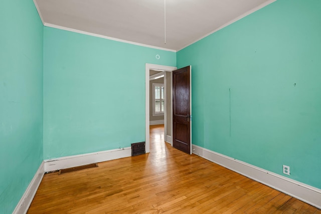 3553 Dupont Ave S, Minneapolis, MN 55408 - empty room featuring ornamental molding, hardwood / wood-style flooring, and baseboards