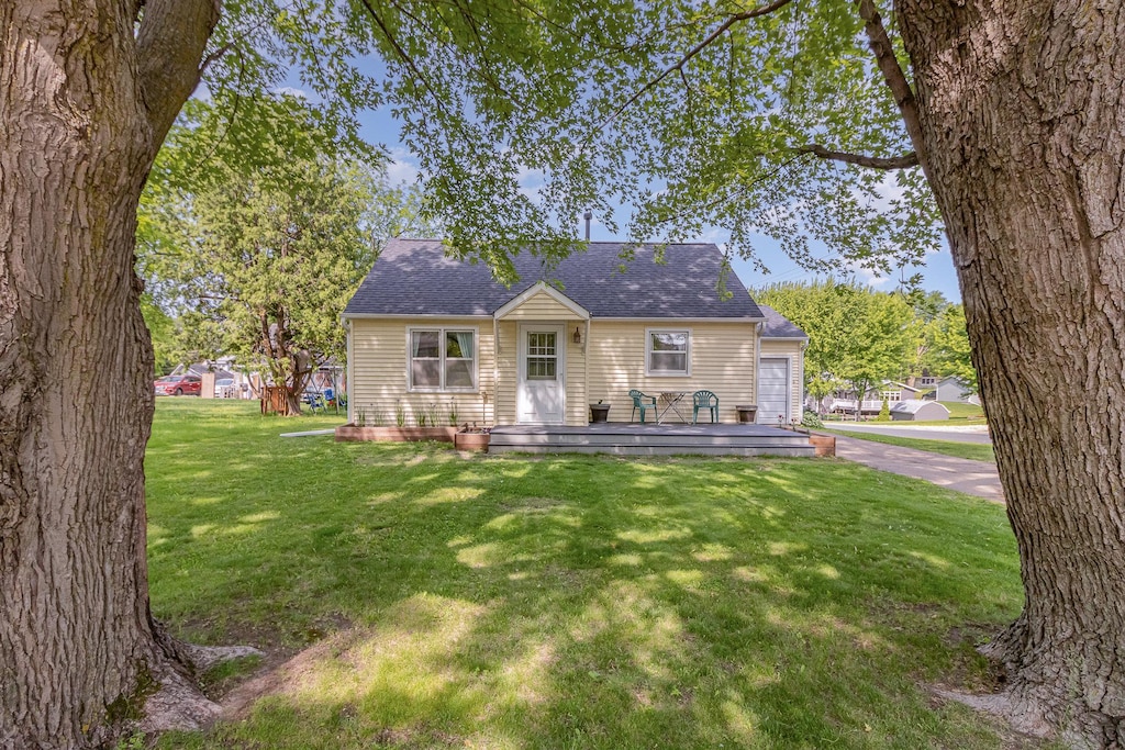 333 Main St N, Lonsdale, MN 55046 - view of front of property with a front yard, roof with shingles, and a wooden deck