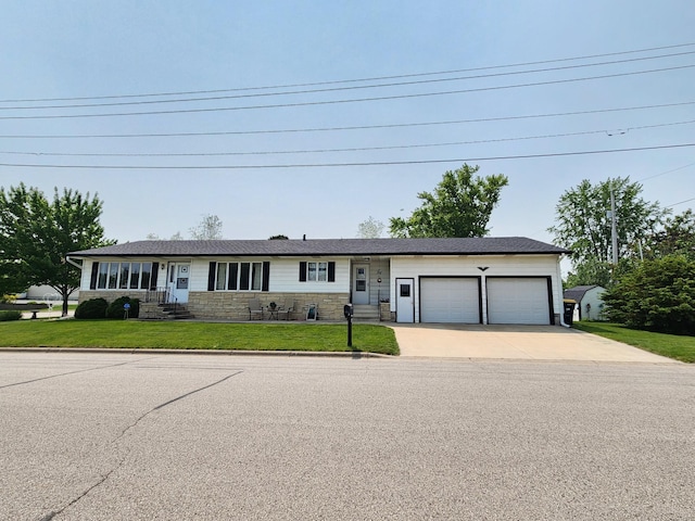 25 3rd Ave NE, Plainview, MN 55964 - single story home with concrete driveway, a garage, stone siding, a front yard, and entry steps