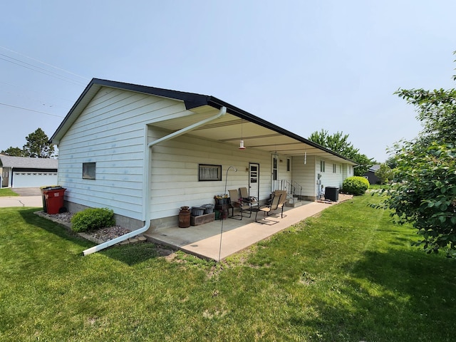 25 3rd Ave NE, Plainview, MN 55964 - back of house with central AC unit, a yard, and a patio