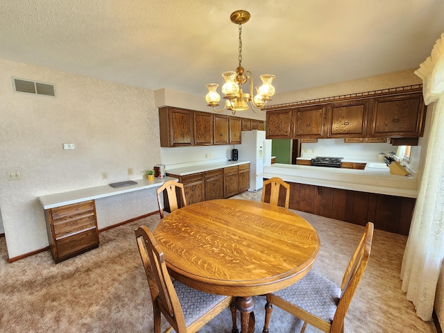 25 3rd Ave NE, Plainview, MN 55964 - kitchen featuring light carpet, a chandelier, light countertops, hanging light fixtures, and white refrigerator with ice dispenser